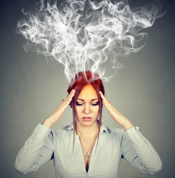 woman thinks very intensely having headache - heat effort emotional stress business imagens e fotografias de stock