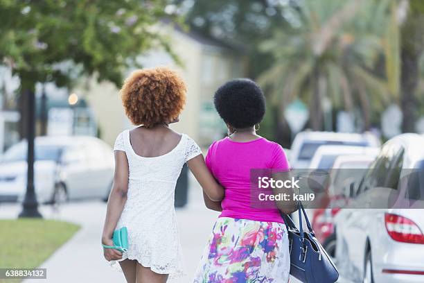 African American woman and adult daughter walking