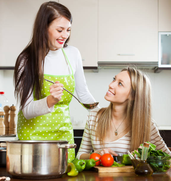 istock Happy girlfriends cooking at home kitchen 638835746