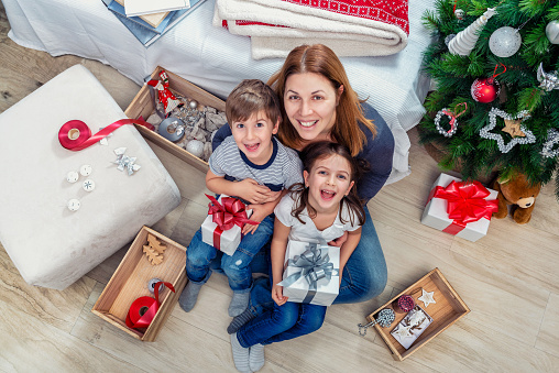 Mother with adorable children holding  holiday presents
