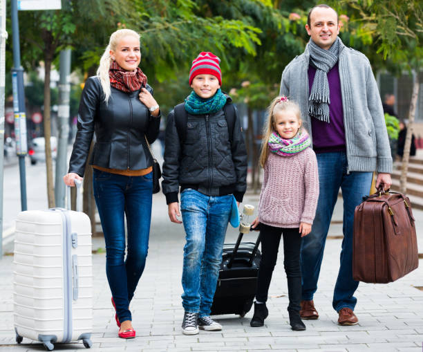 istock Parents with two kids chasing streets 638838114