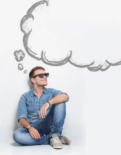 istock Young caucasian man wear sunglasses while sitting on the floor 638840168