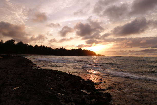 istock Sunset through the clouds and reflecting on the waves 638840650