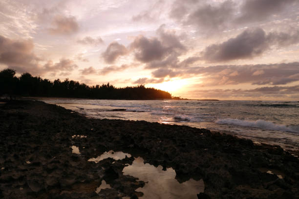 istock Sunset through the clouds and reflecting on the waves 638842780