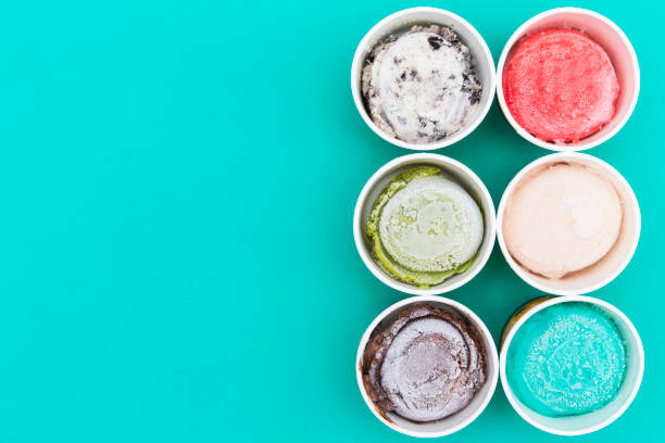 istock Top view Ice cream flavors in cup on green background 638843396