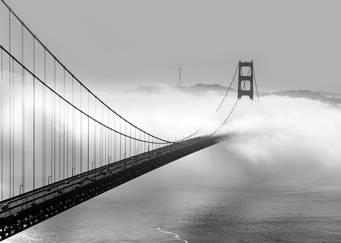 Panoramic view of the western span of the Golden Gate Bridge on a foggy winter morning viewed from Battery Spencer, a Fort Baker site - black and white rendering.