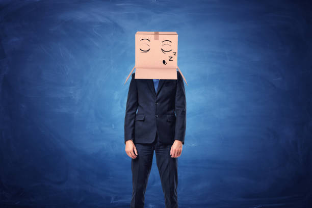 istock Businessman is wearing cardboard box on head with sleepy face 638847006