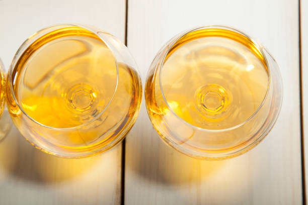 istock Glasses with cognac on a white wooden background 638848196