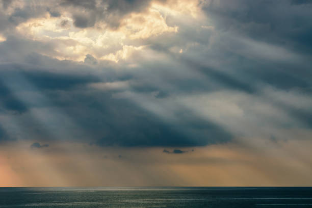 istock Sun's beam through heavy sky over the sea 638849240