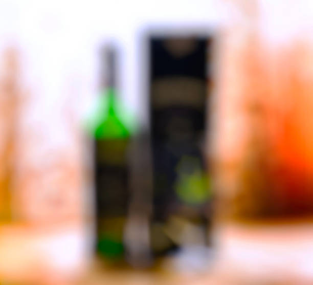 istock Vertical bottle of alcohol with glass and box bokeh background 638850376