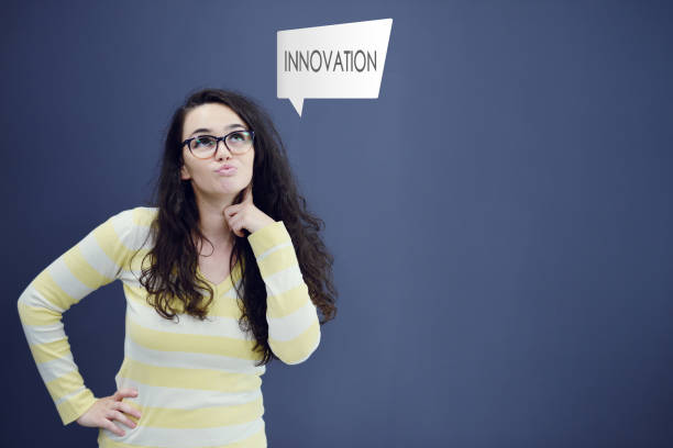 istock Young thinkful woman on blue gray background with finance graphs. 638850644