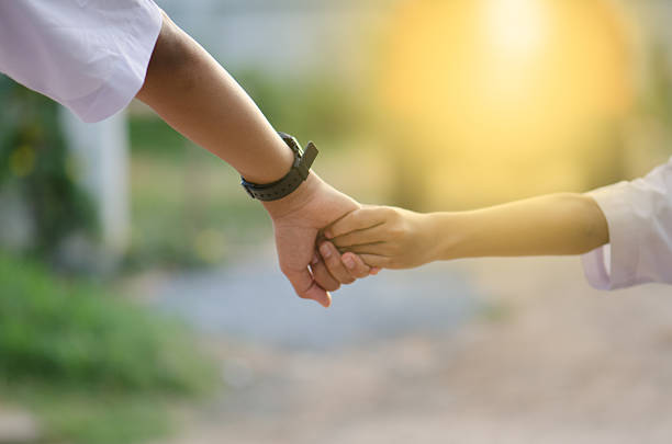istock Brothers holding hands went ahead with concern and ties. Happy 638851654