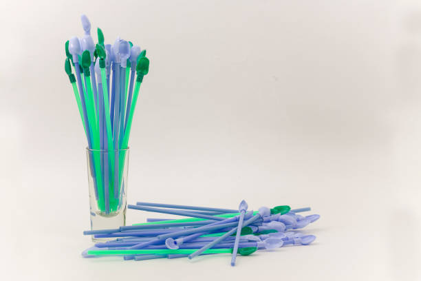 pre-packed colorful plastic straws with spoon stock photo