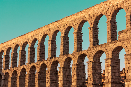 A photo of an ancient Roman aqueduct in Segovia, Spain, slightly toned for a retro look