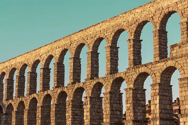 A photo of an ancient Roman aqueduct in Segovia, Spain, slightly toned for a retro look