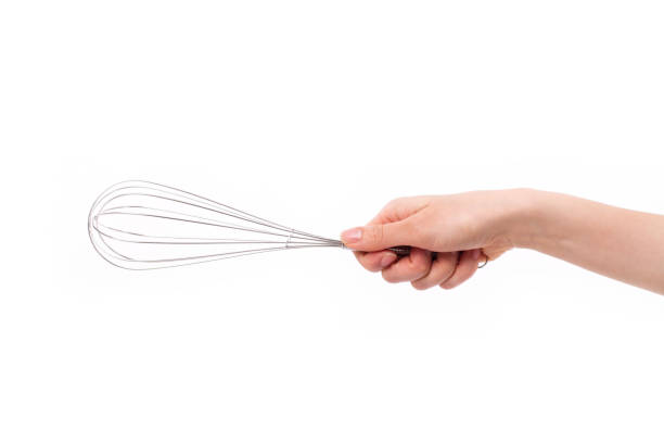 istock baker or chef hand holding whisker, kitchen utensil 638856364