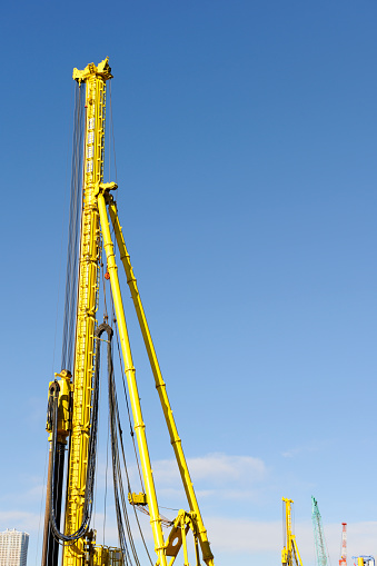 Low angle view of pile driver against clear sky with copy space.