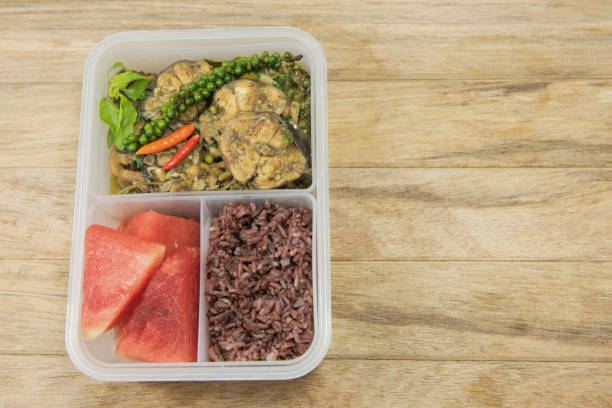istock Spicy stir-fried catfish , riceberry and watermelon in lunch box 638860384