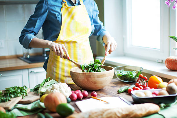 Fresh vegetables Woman cutting vegetables at the kitchen salad bowl photos stock pictures, royalty-free photos & images