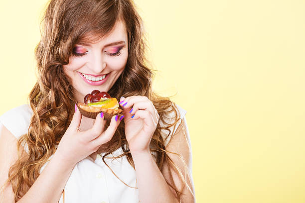 istock Smiling cute woman holds fruit cake in hand 638861856