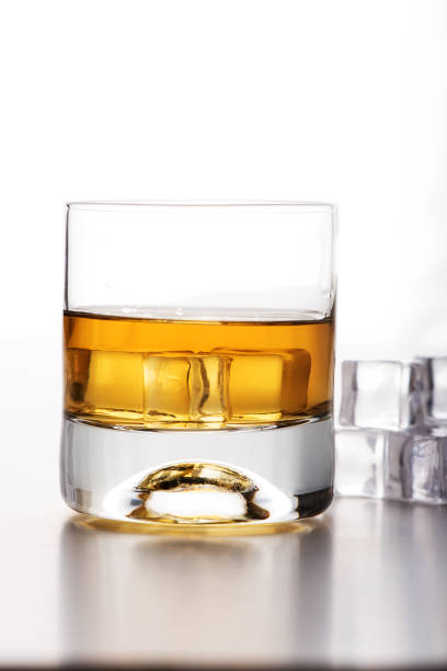 istock Cold malt whiskey with ices and white background 638863396