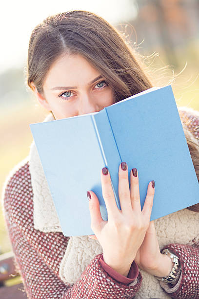 istock Beautiful girl student, reading book outdoor 638865310