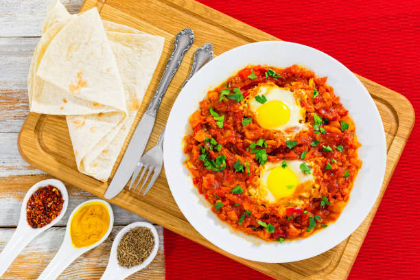 istock shakshuka - eggs,bell pepper, chili, tomato sauce and spices 638868384