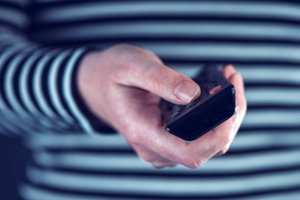 istock Female hand with television remote control 638871044