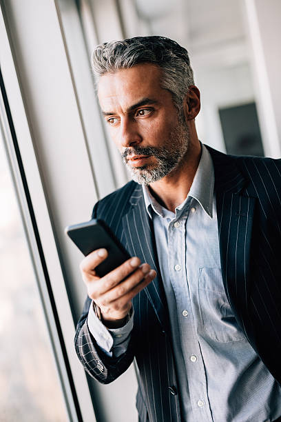istock Businessman Texting On The Phone 638872202