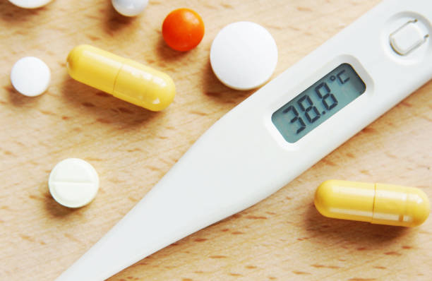 istock Thermometer shows high temperature and many tablets on the table 638873908