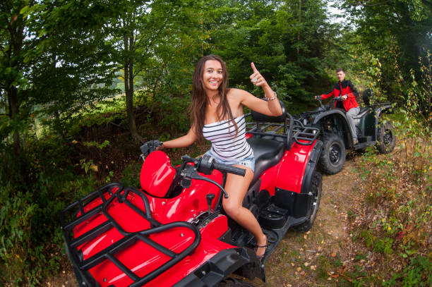Happy couple driving four-wheelers ATV