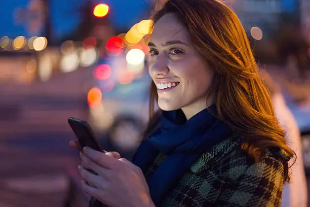 Photo of Young woman texting