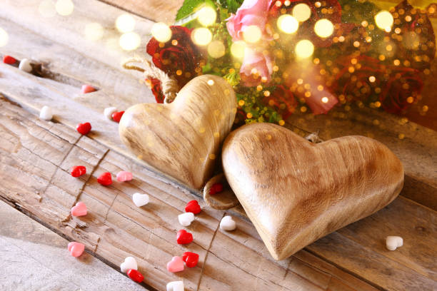 istock Red hearts and roses on wooden table 638877760