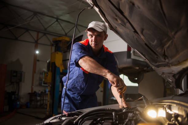 istock Car mechanic working in auto repair service. Repairing car using 638877964