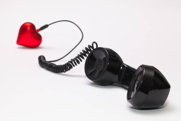 istock Old phone reciever and cord connection with red heart. 638879360