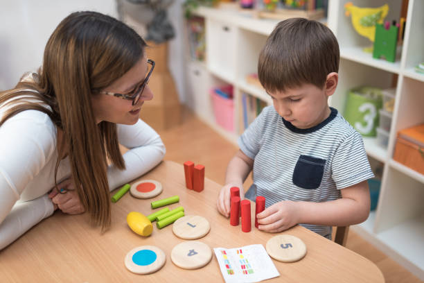 istock Woman looking at kid playing with didactic colorful toys 638880176