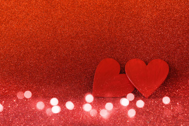 istock Wooden red hearts on red shiny background 638880220