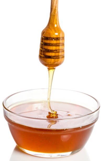 istock Honey dripping from a wooden dipper 638880500