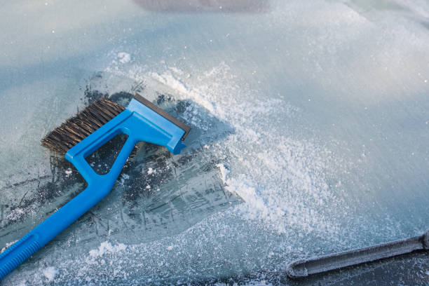 istock ice scraper cleaning a frozen windshield of a car 638880558