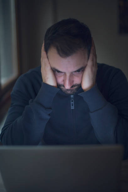 istock Tired man working online at home 638881654