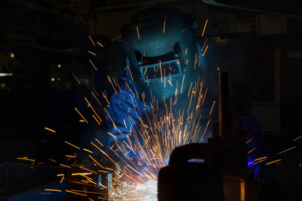 istock Industrial worker is welding in factory 638882798