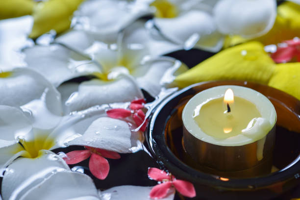 istock Candles  and beautiful flowers in the water spa 638883636