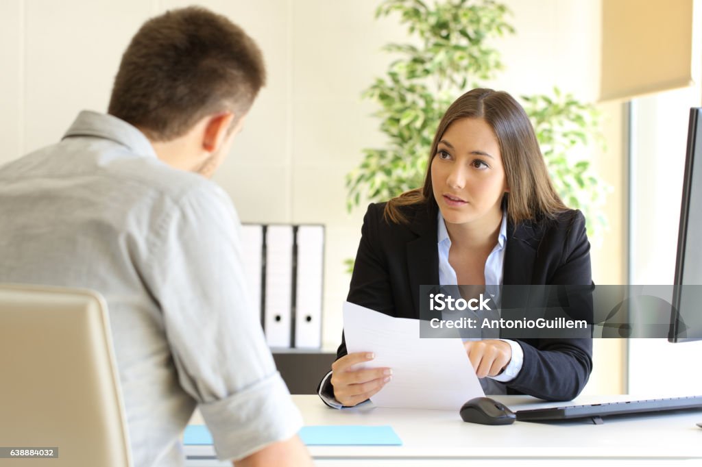 Man searching job during an interview Guy and businesswoman talking in a job interview in an office Discussion Stock Photo