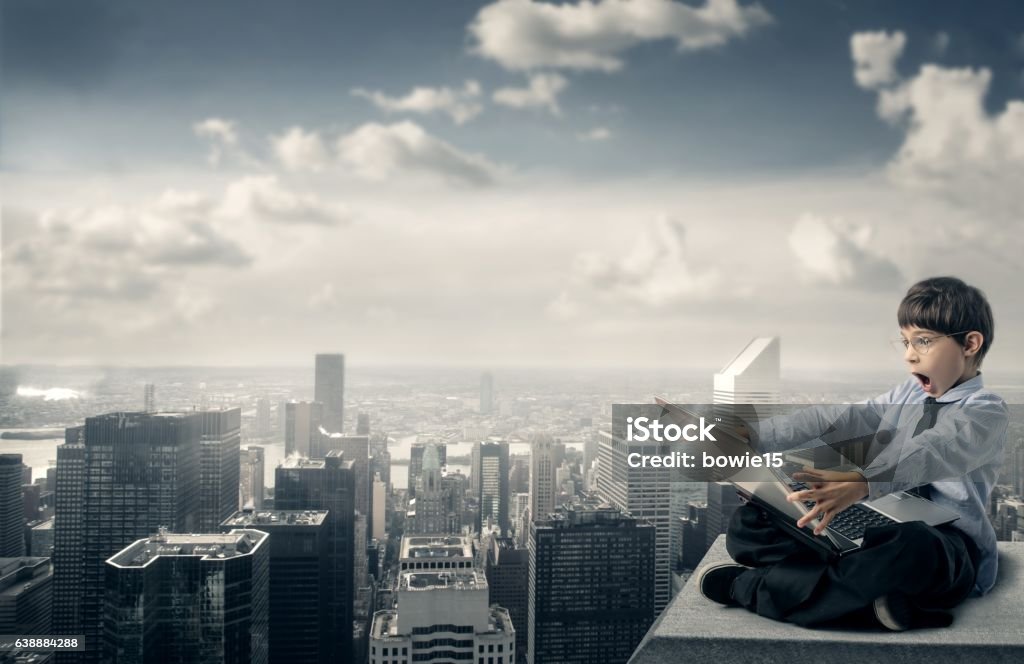 Future profession Little boy dressed up like  a businessman looking at a project and looks amused Aspirations Stock Photo