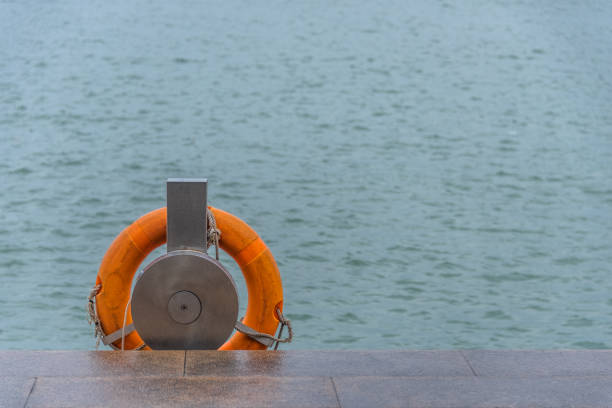 Orange Rescue life buoy by the riverside in China.