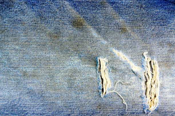 istock Torn and shabby old blue jeans background 638885068