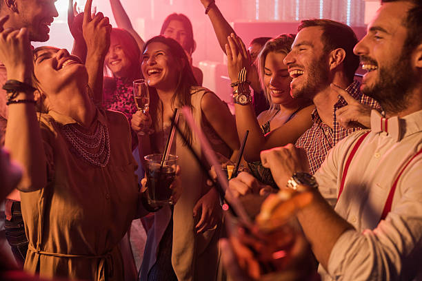 istock Group of happy people dancing together in the disco. 638885402