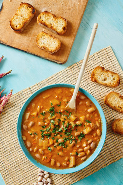 istock Bean soup on a blue plate, surrounded by croutons 638885850