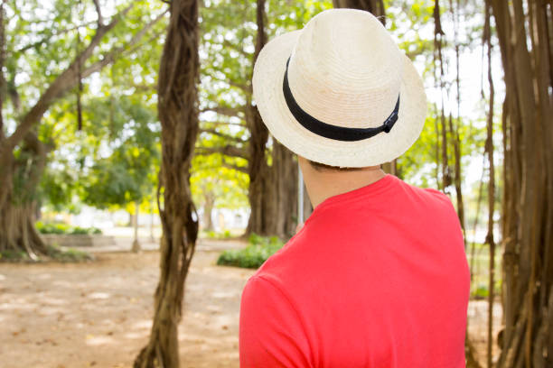 istock Man stands with his back to us in white hat 638885870