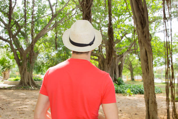 istock Man stands with his back to us in white hat 638886192